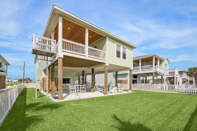 back of house with a lawn and a patio area