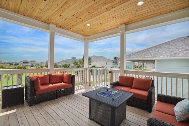 deck featuring an outdoor living space with a fire pit