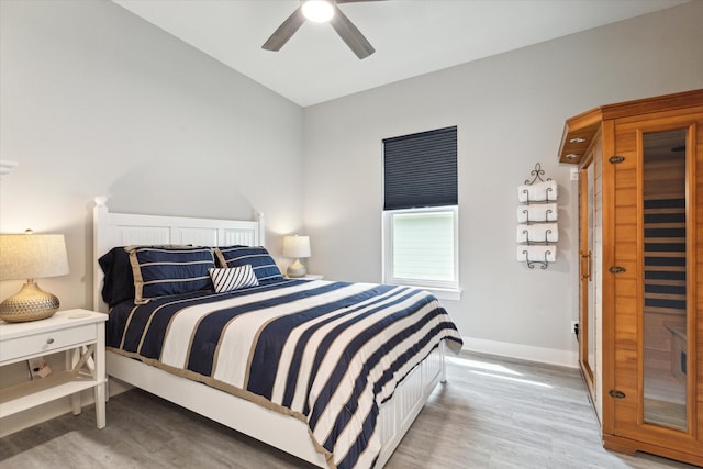 bedroom with light hardwood / wood-style floors and ceiling fan