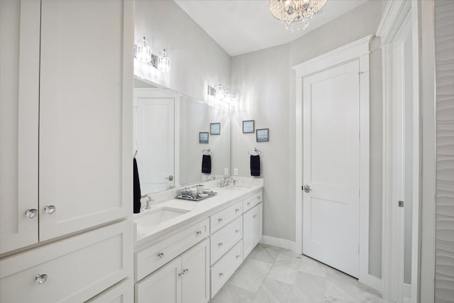 bathroom with vanity and an inviting chandelier