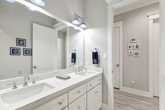 bathroom featuring hardwood / wood-style floors, vanity, and ornamental molding