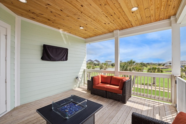 deck with an outdoor living space with a fire pit