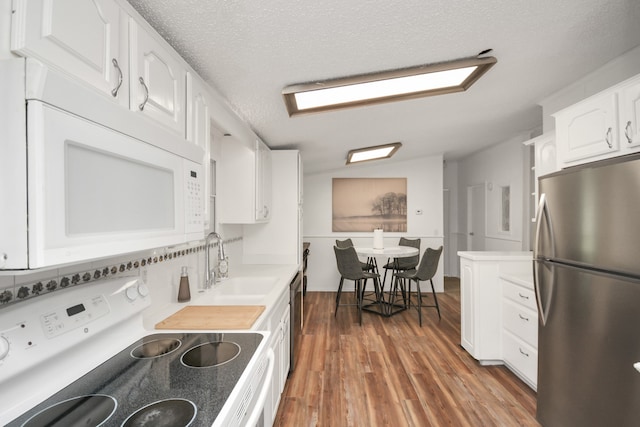 kitchen with dark wood-type flooring, sink, a textured ceiling, appliances with stainless steel finishes, and white cabinetry