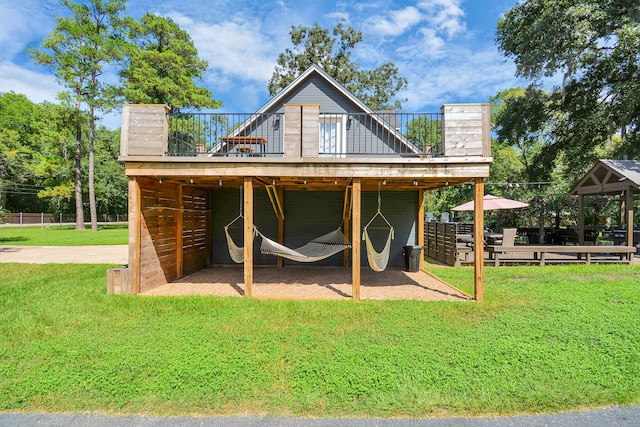 rear view of house with a yard and a deck