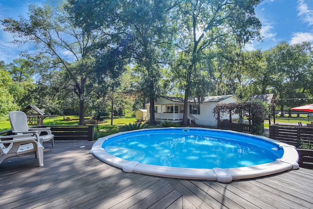 view of swimming pool featuring a deck