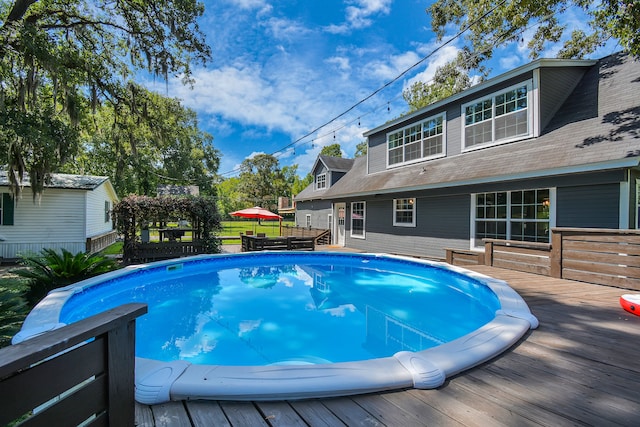 view of swimming pool featuring a deck