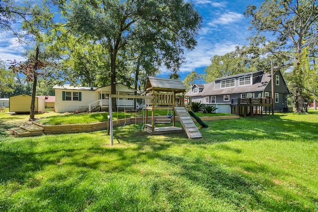 rear view of house with a playground and a lawn