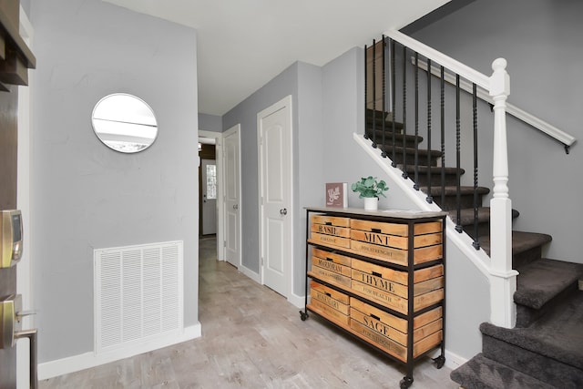 stairs featuring hardwood / wood-style flooring