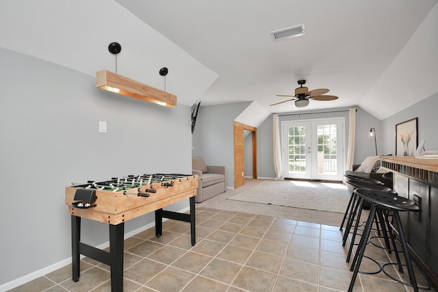 recreation room with french doors, ceiling fan, lofted ceiling, and light tile patterned flooring