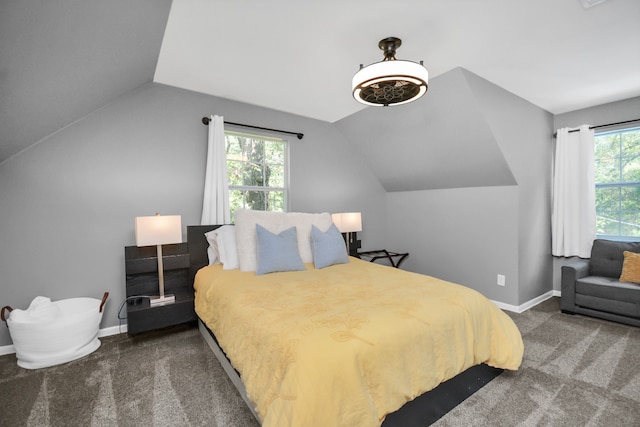 bedroom with carpet floors, multiple windows, and lofted ceiling