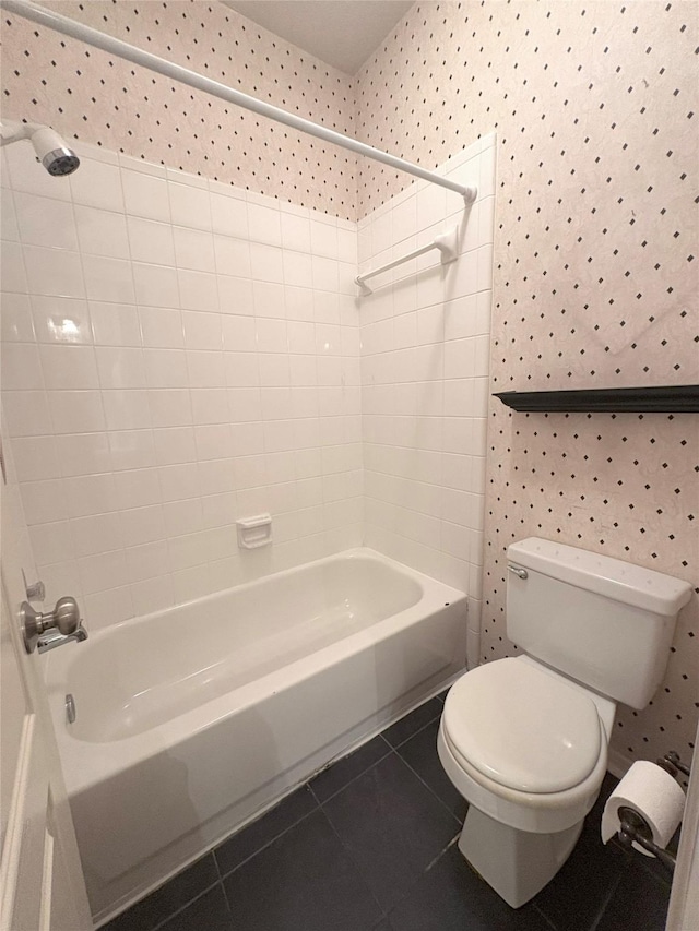 bathroom with toilet, tile patterned flooring, and tub / shower combination