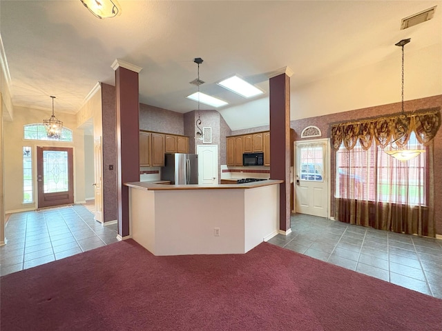 kitchen featuring hanging light fixtures, kitchen peninsula, stainless steel fridge, lofted ceiling, and light carpet