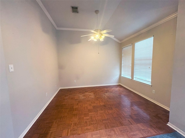 spare room with dark parquet floors, vaulted ceiling, ceiling fan, and ornamental molding