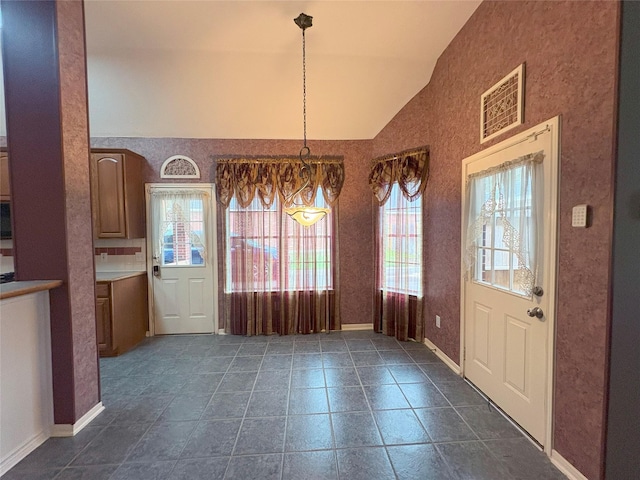 unfurnished dining area with lofted ceiling