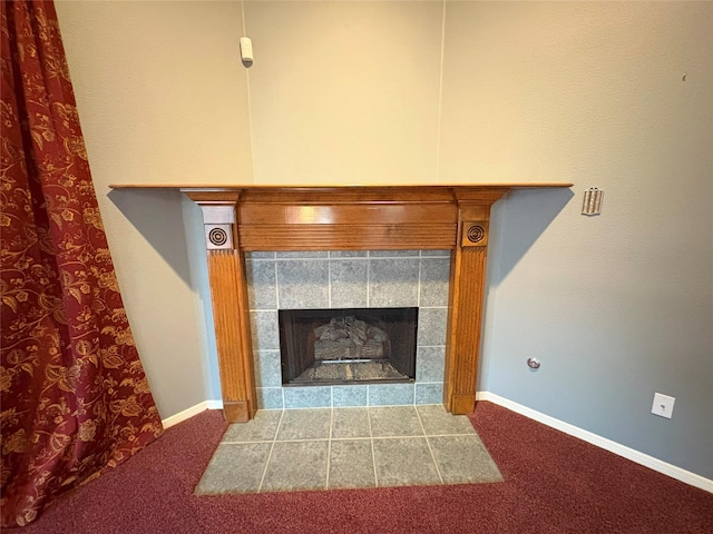 room details with a tile fireplace and carpet floors