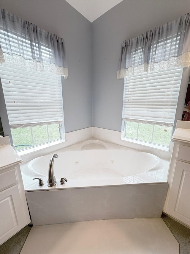 bathroom with vanity and a tub