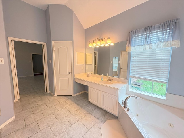 bathroom featuring tile patterned flooring, vanity, tiled tub, and vaulted ceiling