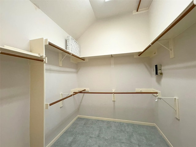 walk in closet with vaulted ceiling