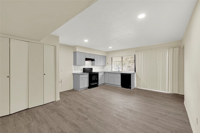 kitchen with sink, light hardwood / wood-style floors, gray cabinetry, and black appliances