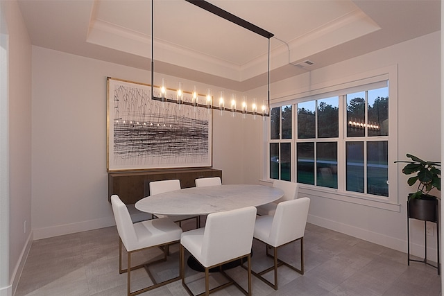 dining space featuring a raised ceiling