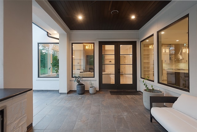 view of exterior entry featuring french doors and a patio area