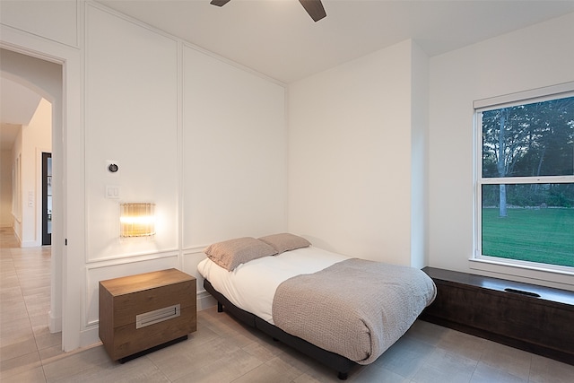 bedroom featuring multiple windows and ceiling fan