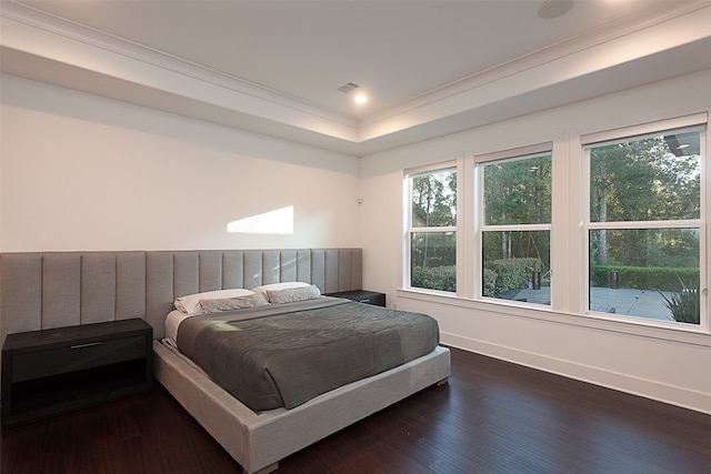 bedroom featuring ornamental molding, multiple windows, and dark wood-type flooring