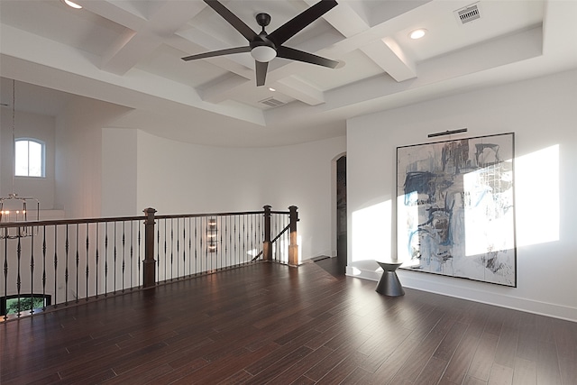 empty room featuring beam ceiling, dark hardwood / wood-style flooring, ceiling fan, and coffered ceiling