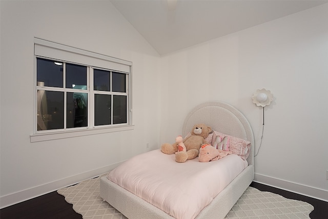 bedroom with hardwood / wood-style floors and vaulted ceiling