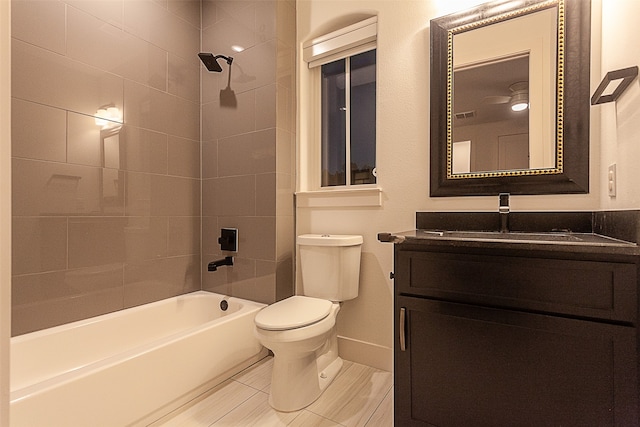 full bathroom featuring toilet, vanity, and tiled shower / bath