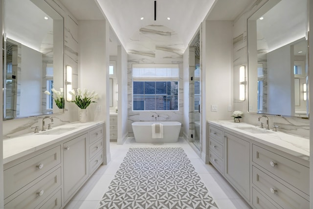 bathroom featuring tile patterned floors, vanity, and plus walk in shower