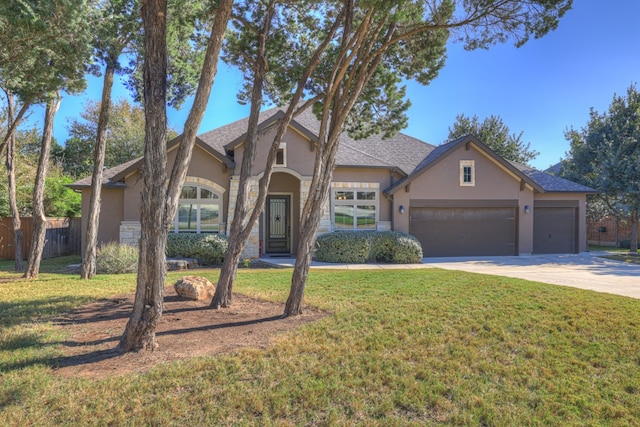 view of front of property with a garage and a front lawn