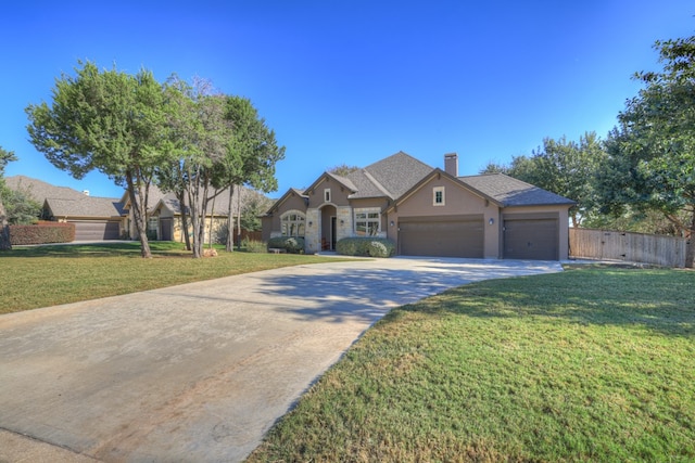 single story home featuring a garage and a front lawn