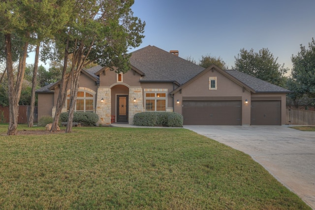 view of front of property featuring a garage and a front yard