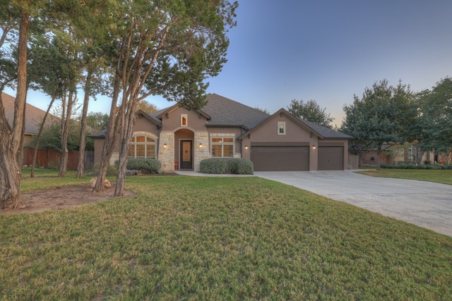 view of front of house featuring a front yard and a garage