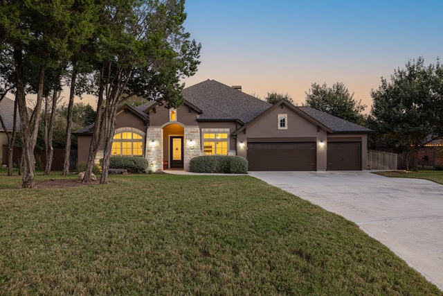 view of front of house with a lawn and a garage