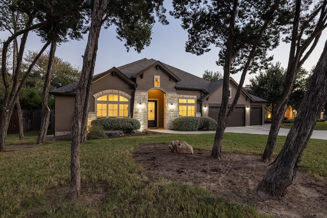 view of front of property with a yard and a garage