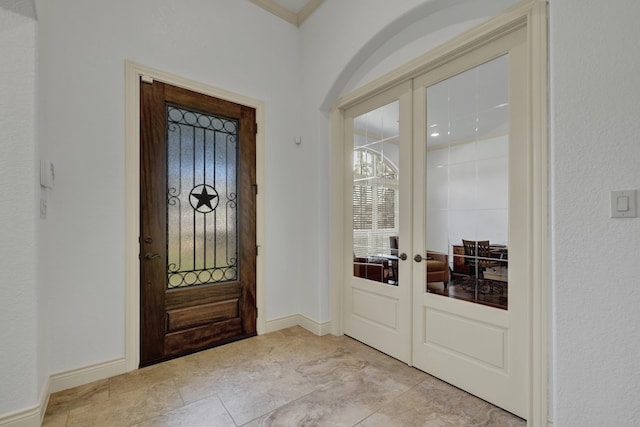 entryway with french doors and ornamental molding