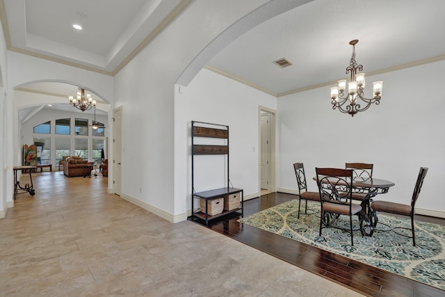 dining space featuring a chandelier, light wood-type flooring, and crown molding