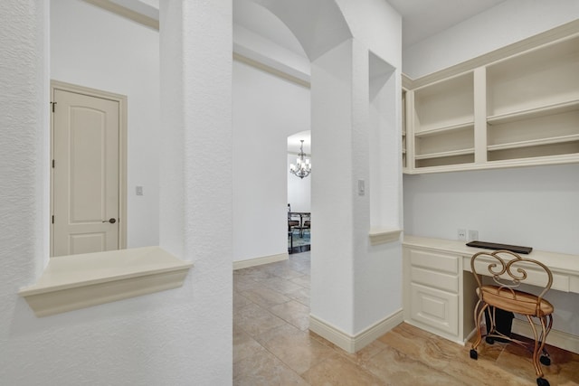 interior space with light tile patterned floors and a chandelier