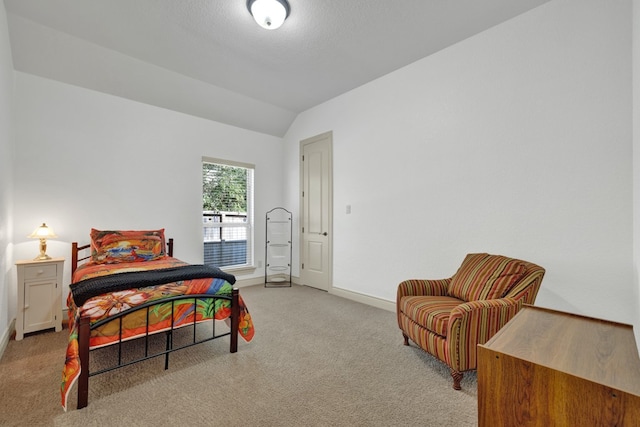 carpeted bedroom with lofted ceiling