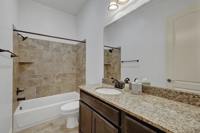 full bathroom featuring vanity, tiled shower / bath combo, and toilet