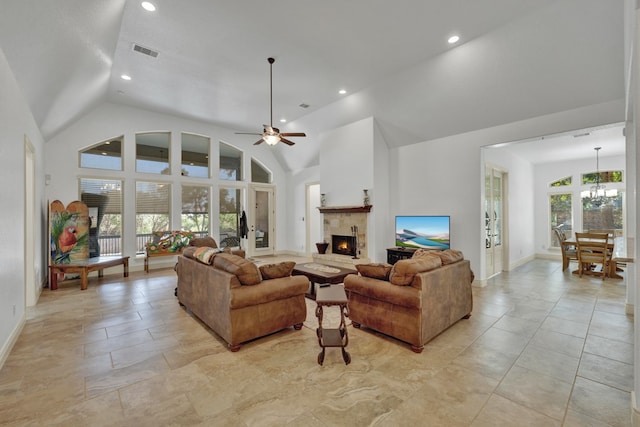 living room featuring ceiling fan with notable chandelier and high vaulted ceiling