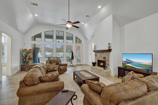 tiled living room with a fireplace, high vaulted ceiling, and ceiling fan