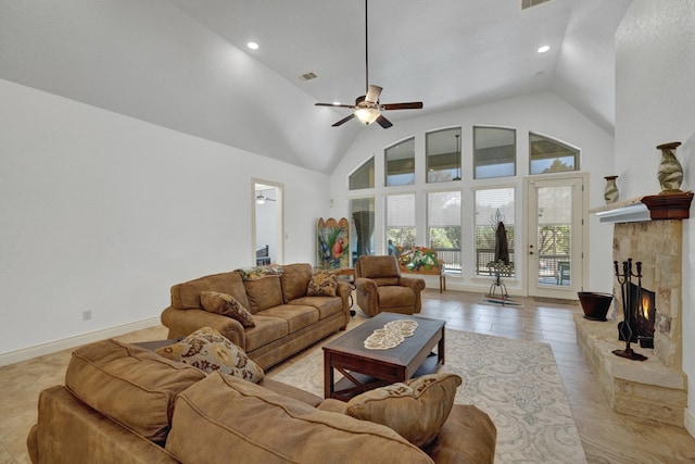 tiled living room featuring ceiling fan, a stone fireplace, and high vaulted ceiling