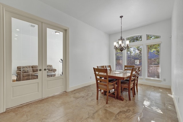 dining room with a notable chandelier and french doors