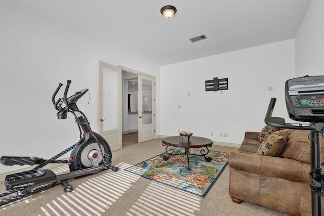 exercise area featuring french doors and light colored carpet