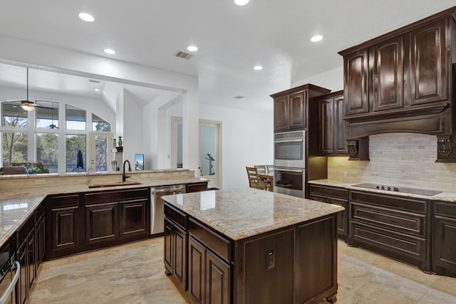 kitchen featuring a center island, sink, black electric stovetop, vaulted ceiling, and dark brown cabinets