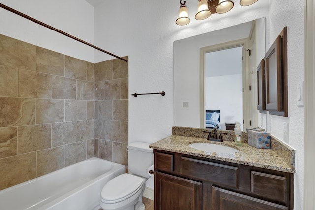 full bathroom featuring vanity, toilet, and tiled shower / bath