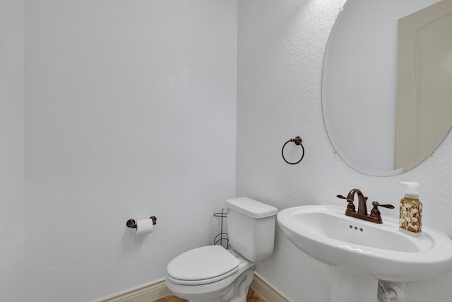 bathroom with toilet and sink